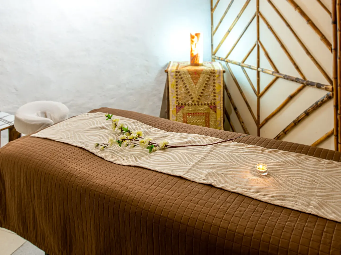 Spa treatment bed with flowers and candle at Park Royal Beach Ixtapa.