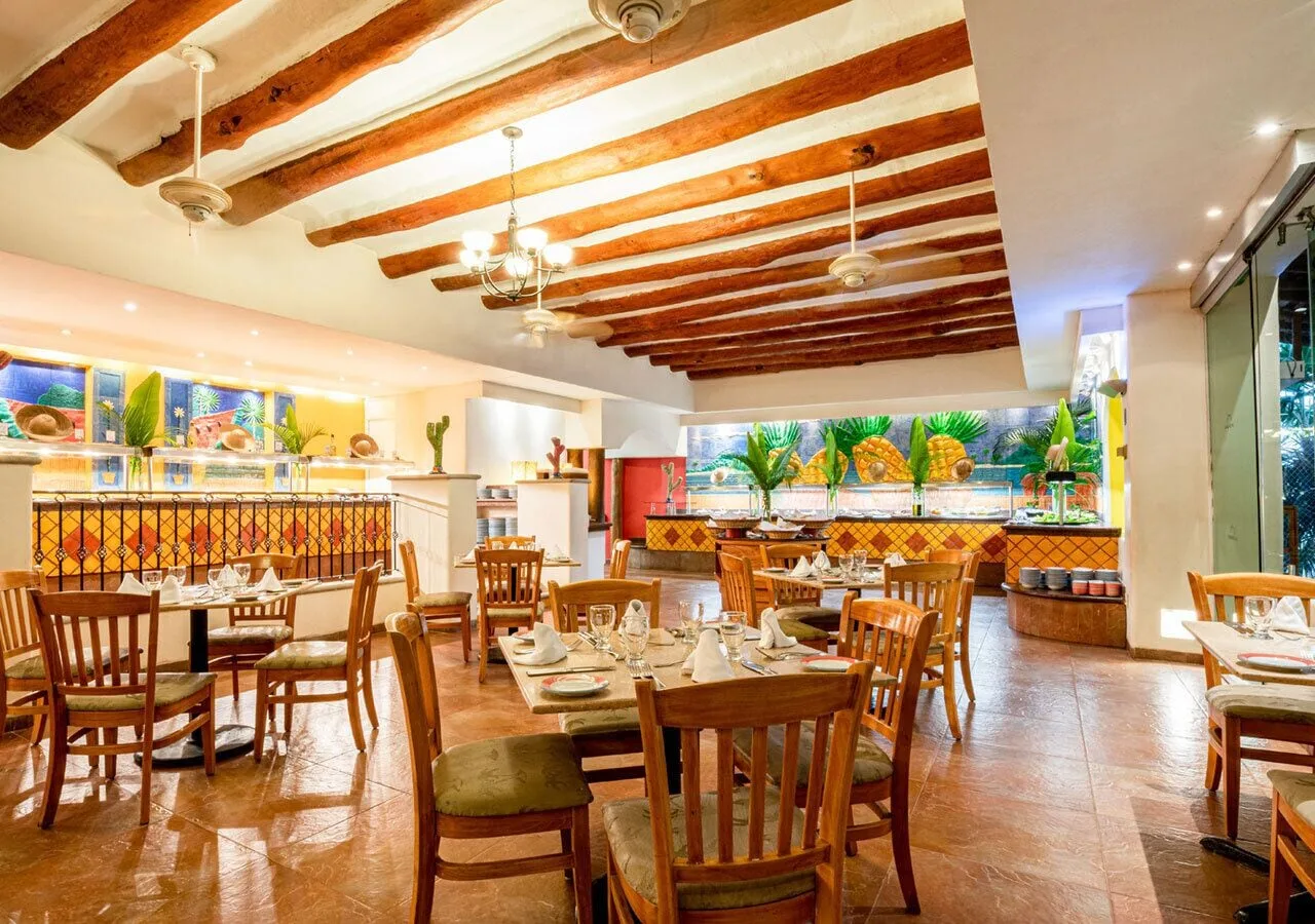 Buffet dining room with wooden tables at Park Royal Beach Ixtapa.