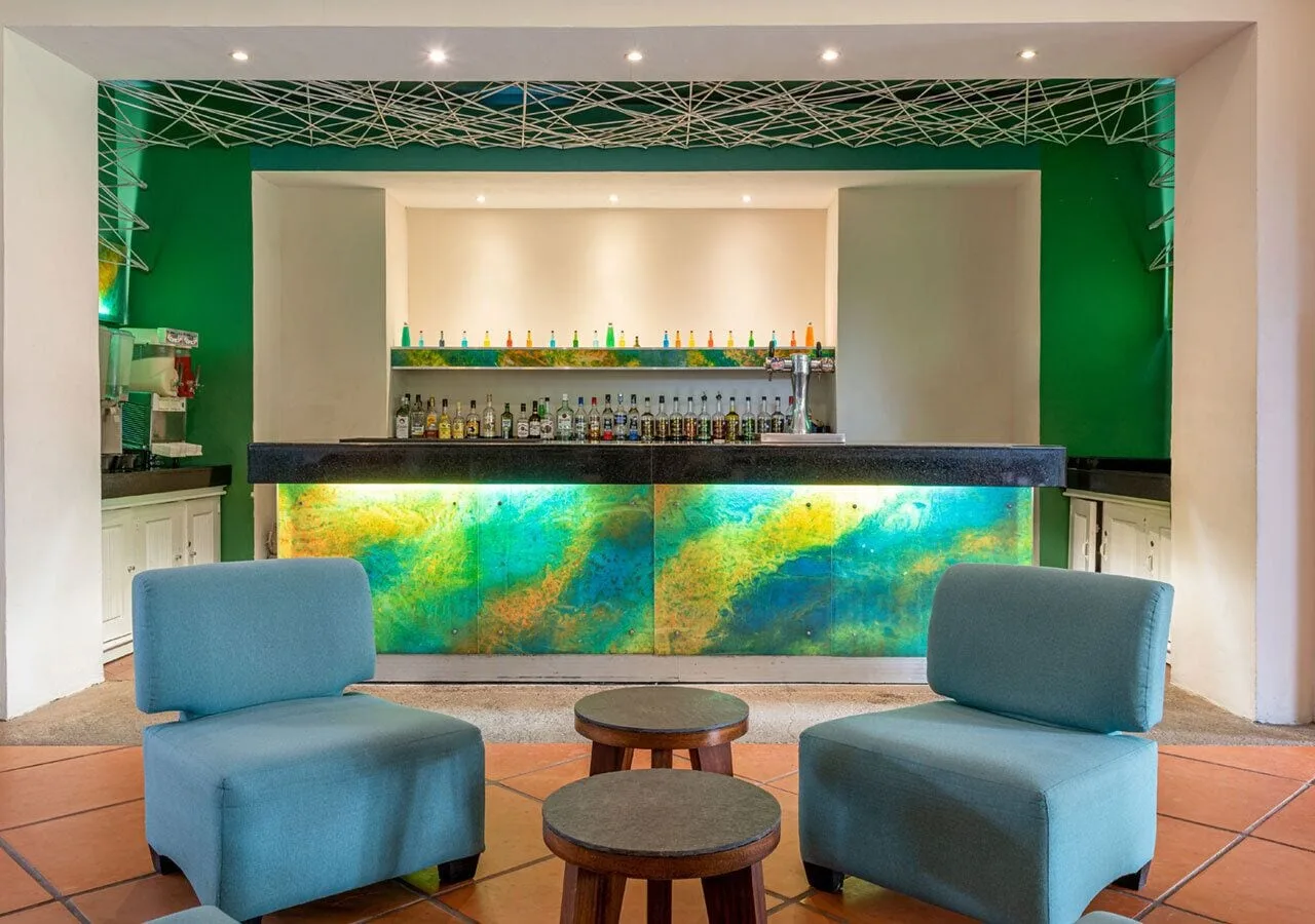 Indoor bar with turquoise lounge chairs at Park Royal Beach Ixtapa.