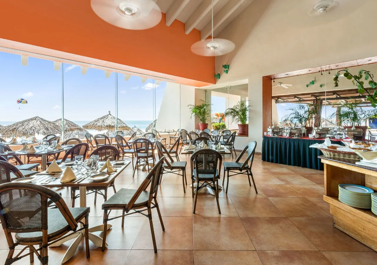 Ocean-view restaurant with buffet and beach umbrellas at Park Royal Beach Ixtapa.