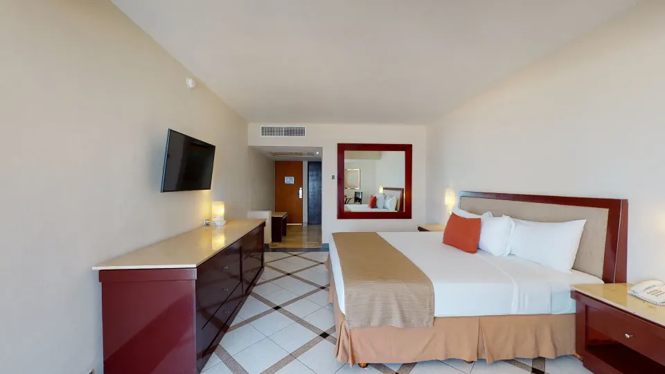 Deluxe Nature View king room with TV and mirror at Park Royal Beach Ixtapa.