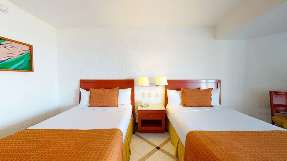 Deluxe Nature View room with two double beds at Park Royal Beach Ixtapa.