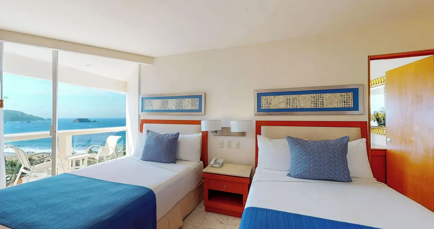 Master Suite bedroom with two beds and balcony ocean view at Park Royal Beach Ixtapa.