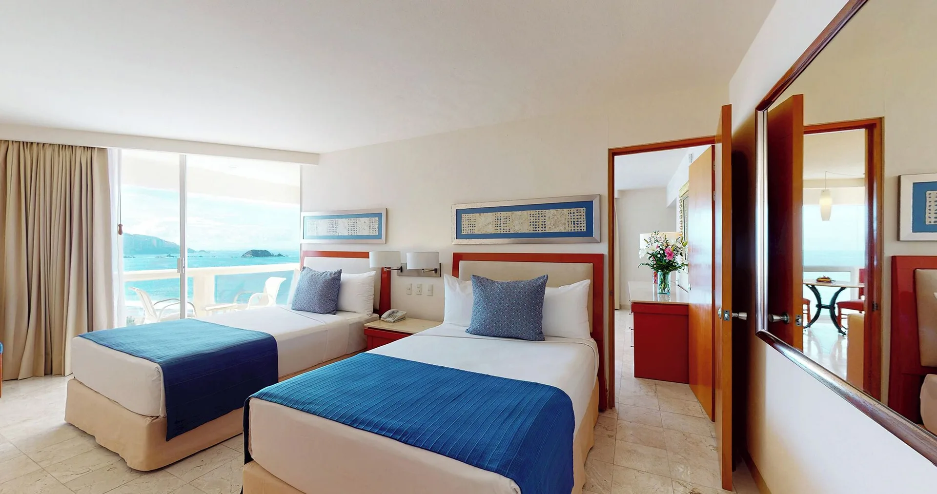 Master Suite bedroom with two double beds and ocean-facing balcony at Park Royal Beach Ixtapa.