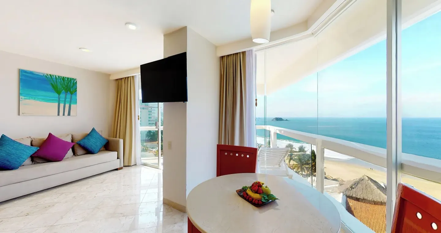 Master Suite dining nook with ocean-view windows and sofa at Park Royal Beach Ixtapa.