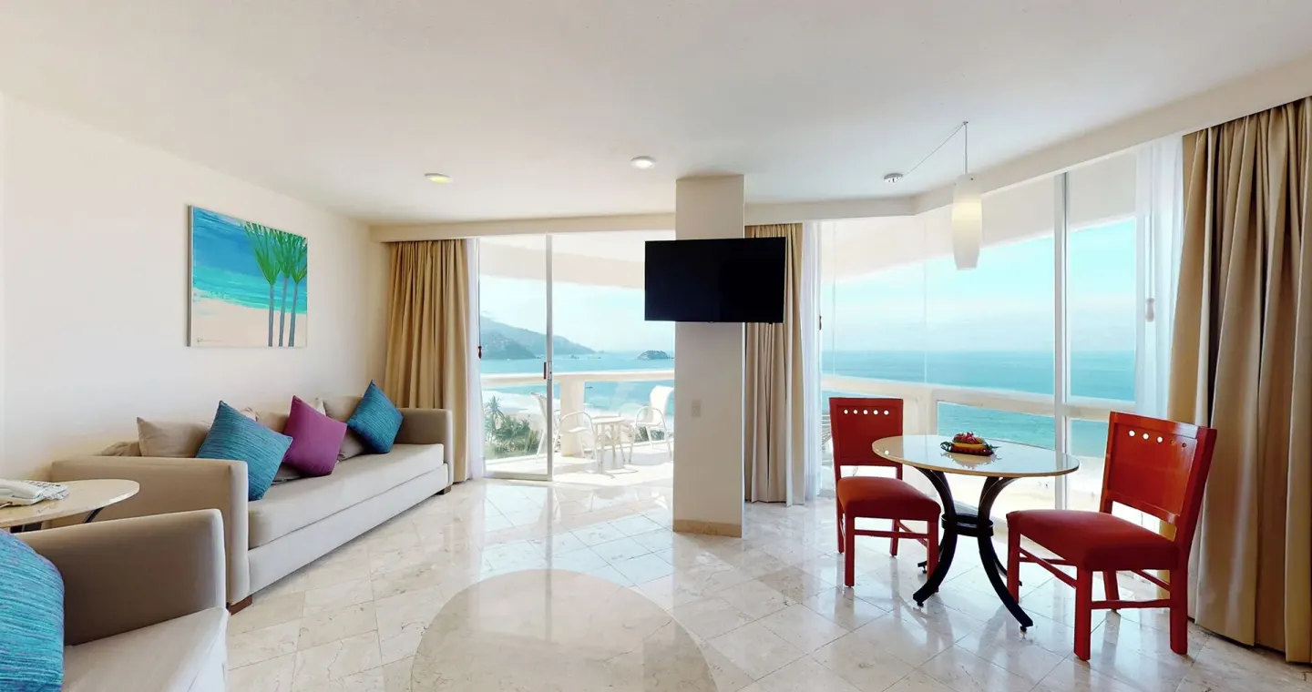 Master Suite ocean-view living room with sofa and dining table at Park Royal Beach Ixtapa.