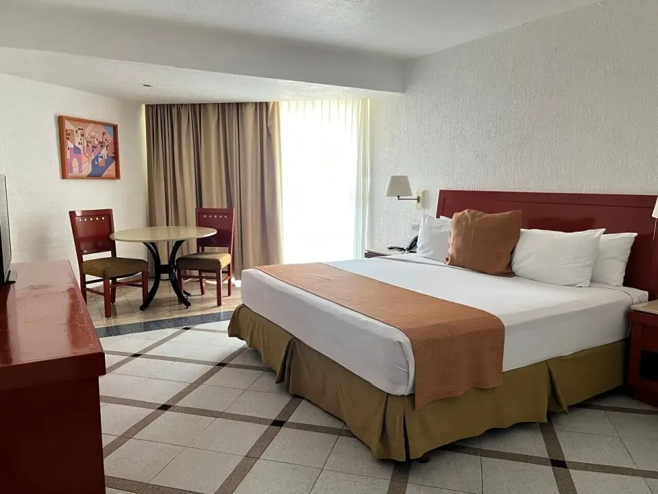 Premier Ocean Front room with king bed and sitting area at Park Royal Beach Ixtapa.