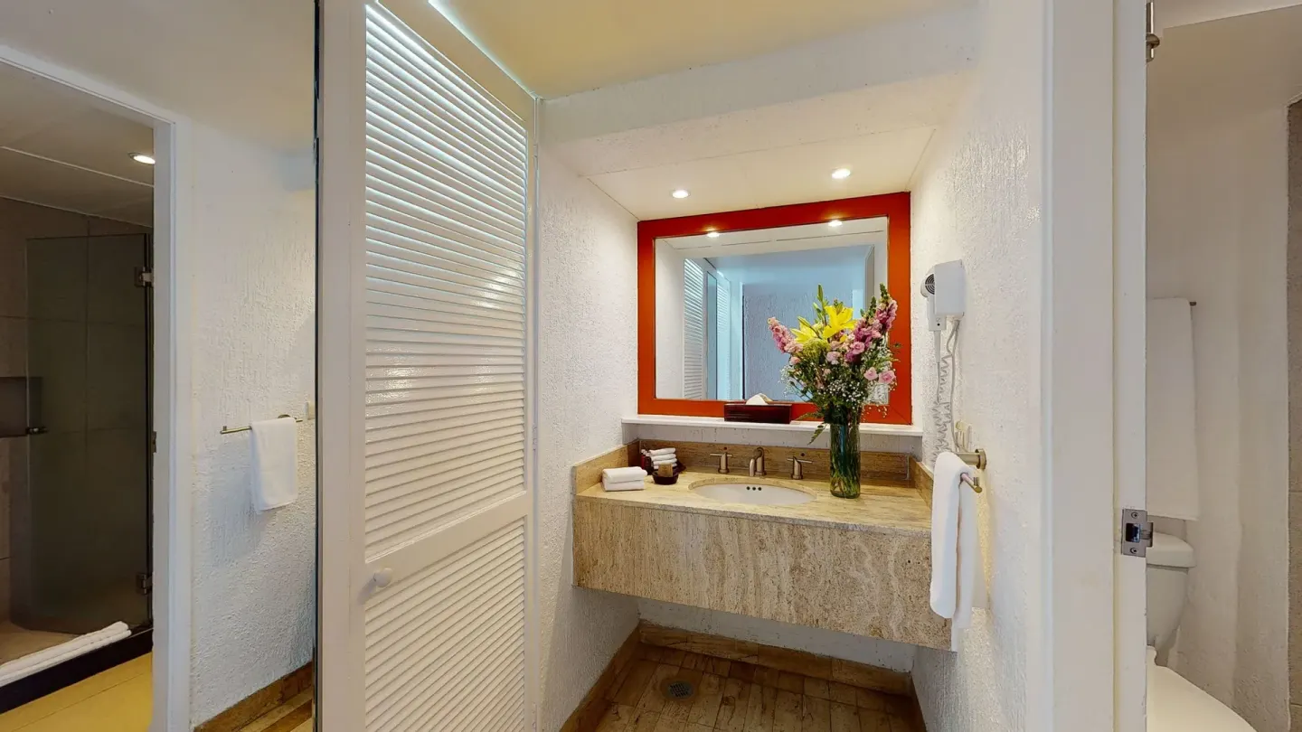 Premier Ocean View bathroom vanity with flowers at Park Royal Beach Ixtapa.