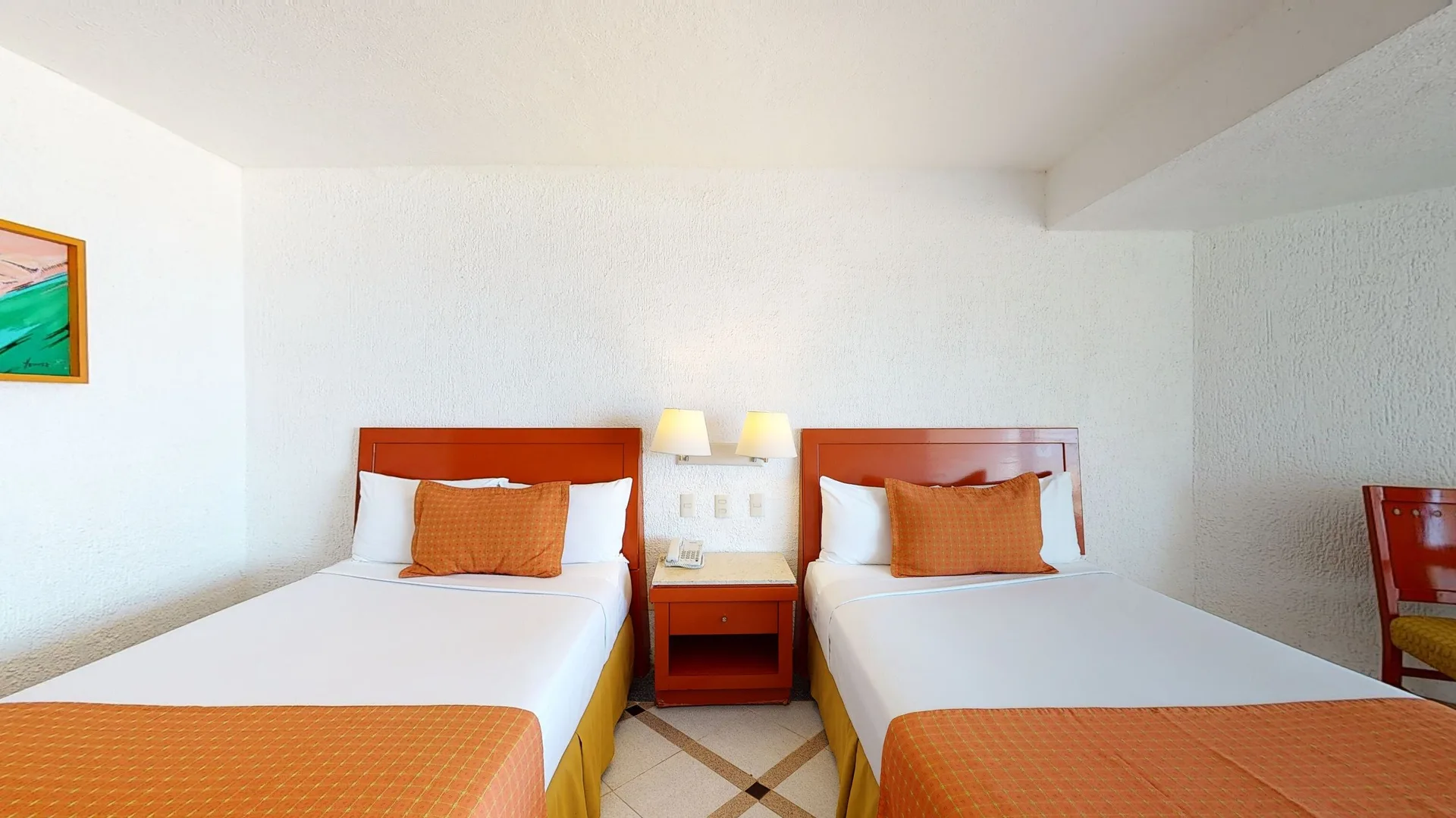 Premier Ocean View room with two beds and bedside lamps at Park Royal Beach Ixtapa.