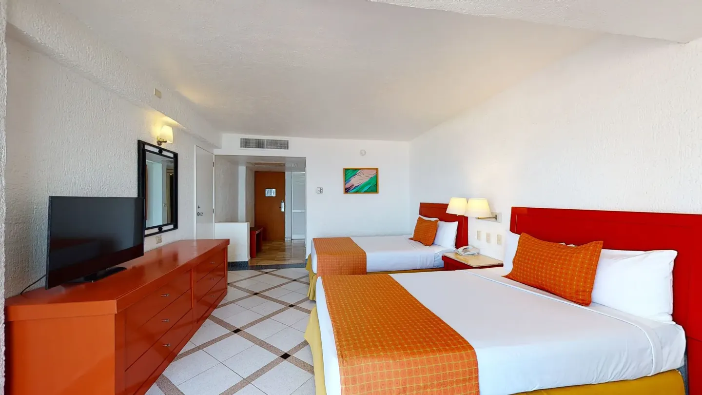 Premier Ocean View room with two beds and dresser at Park Royal Beach Ixtapa.