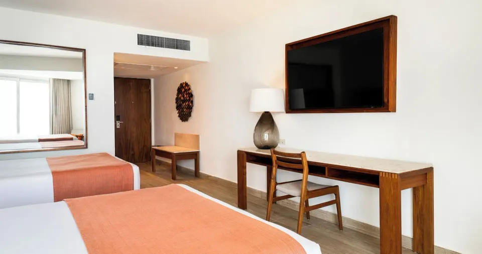 Royal Ocean View guest room desk and TV area at Park Royal Beach Ixtapa.