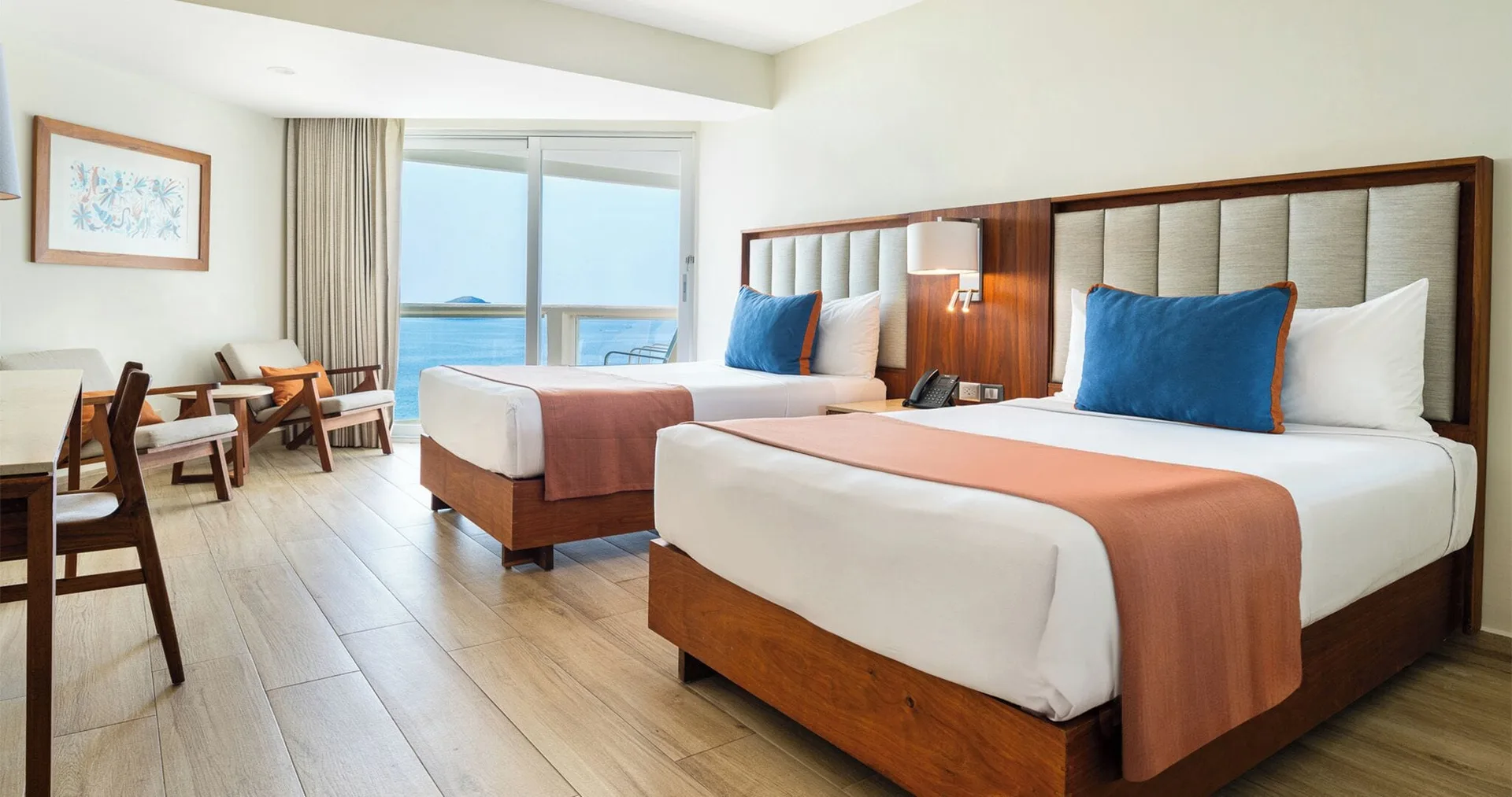 Royal Ocean View guest room with two beds and balcony at Park Royal Beach Ixtapa.