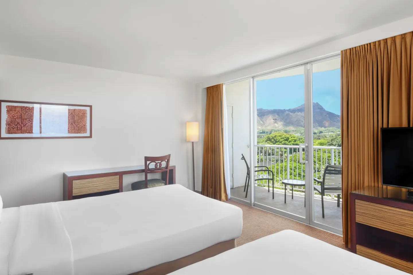 Guest room with two beds, balcony, and Diamond Head view at Park Shore Waikiki.