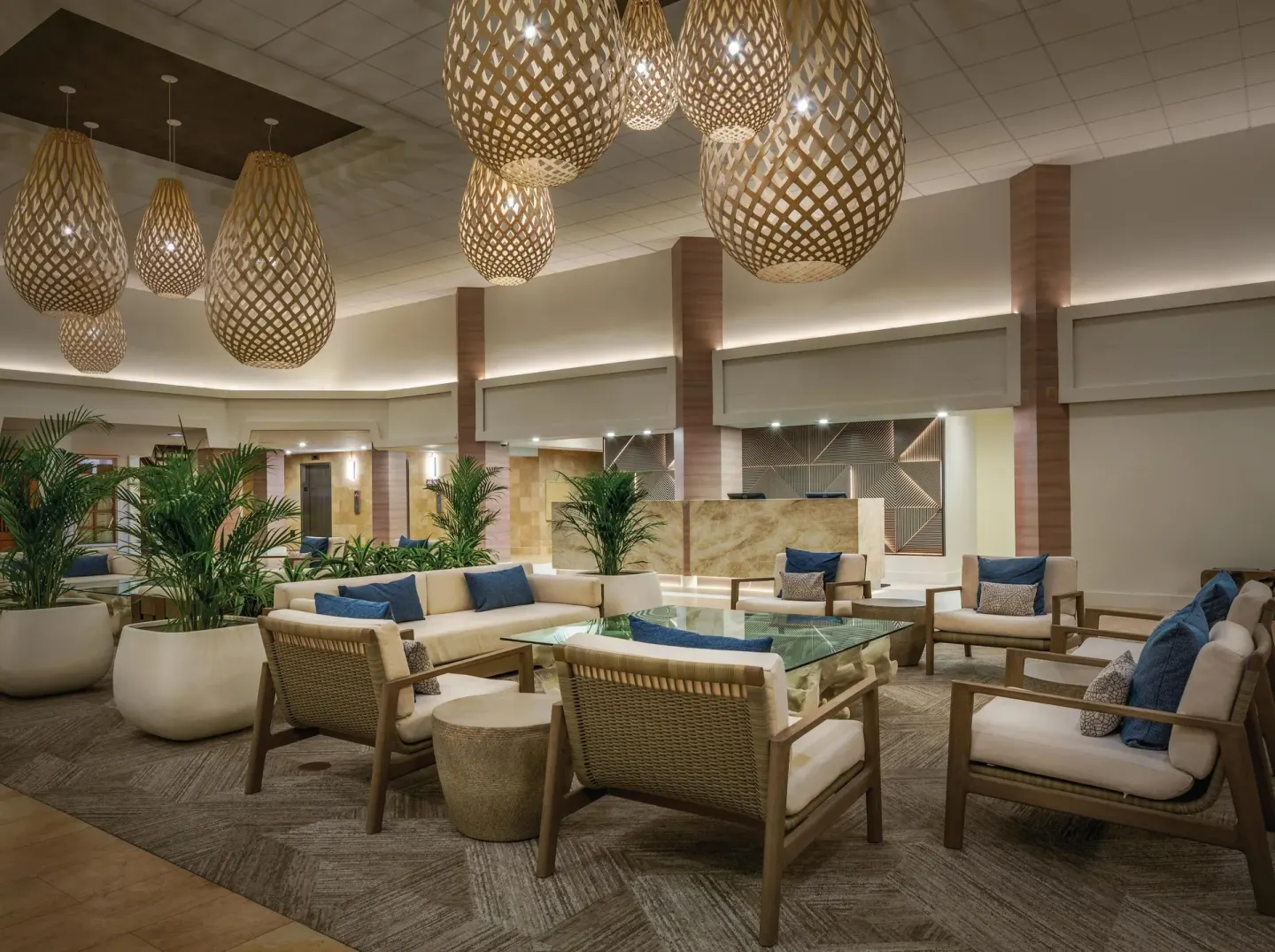 Lobby seating area with woven pendant lights at Park Shore Waikiki.