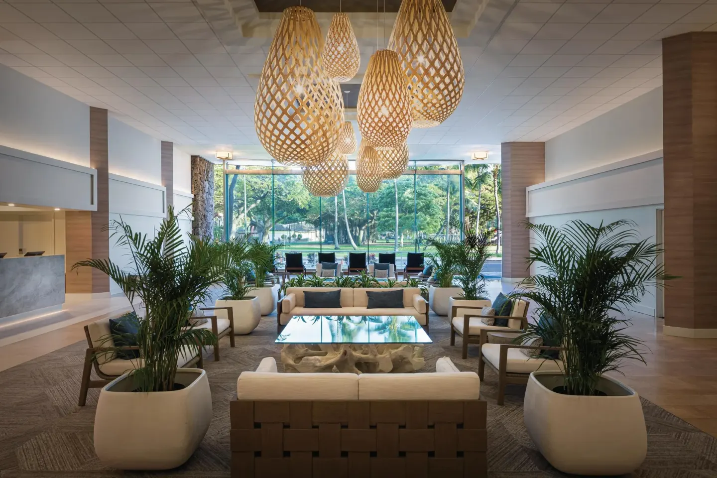 Lobby seating facing tall windows and greenery at Park Shore Waikiki.