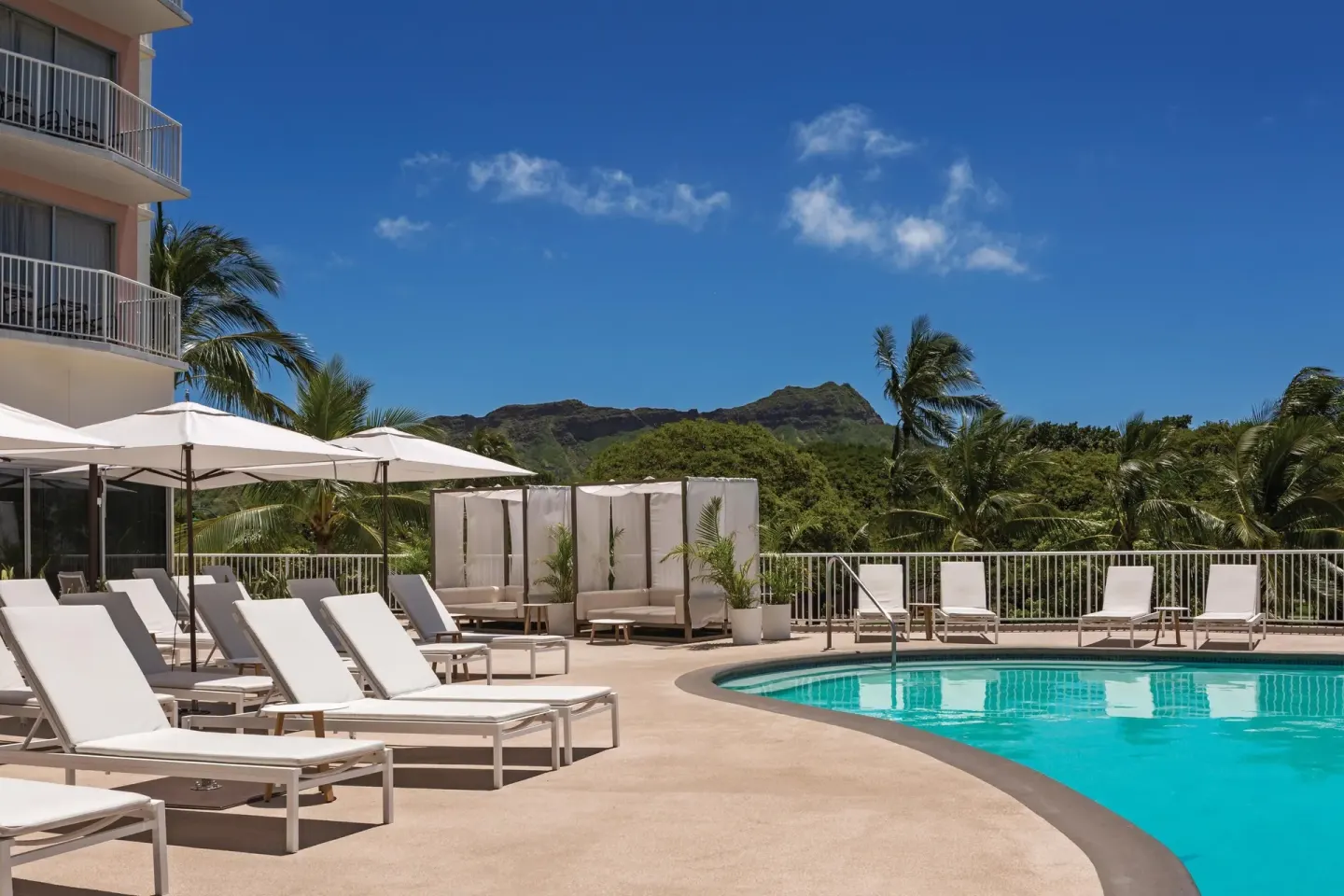 Pool deck with loungers, umbrellas, and Diamond Head views at Park Shore Waikiki.