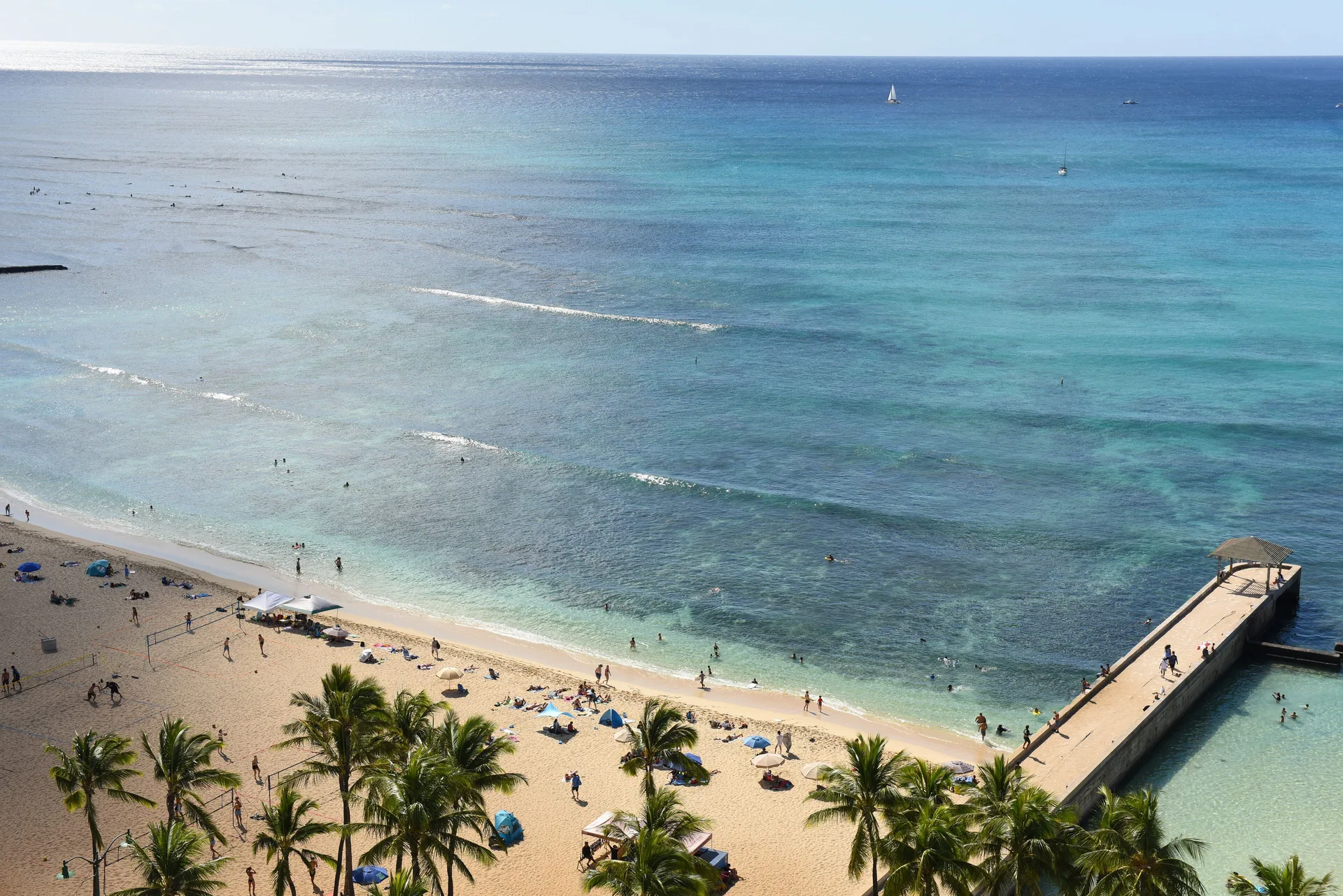 Waikiki Beach, turquoise ocean, swimmers, and pier near Park Shore Waikiki.