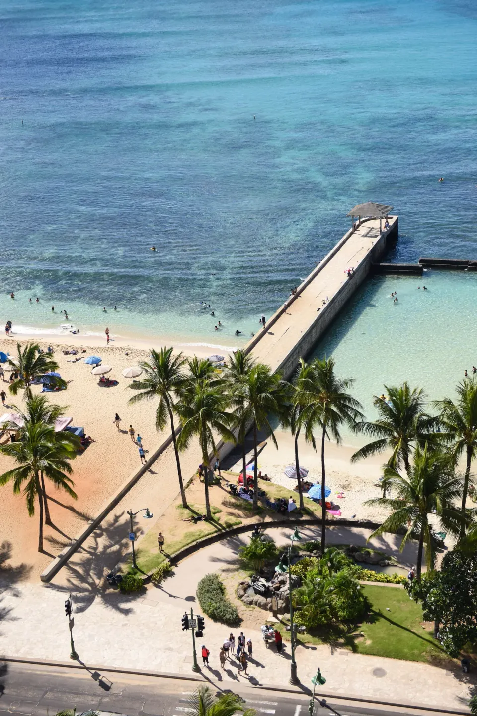 Waikiki pier, beach, palms, and blue ocean near Park Shore Waikiki.