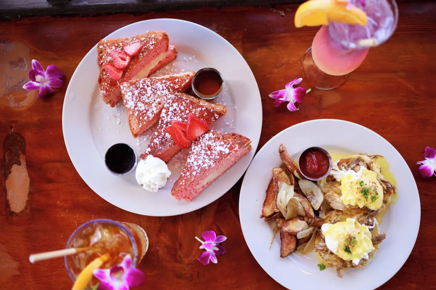 Overhead brunch with French toast, eggs, orchids, and drinks at Park Shore Waikiki.