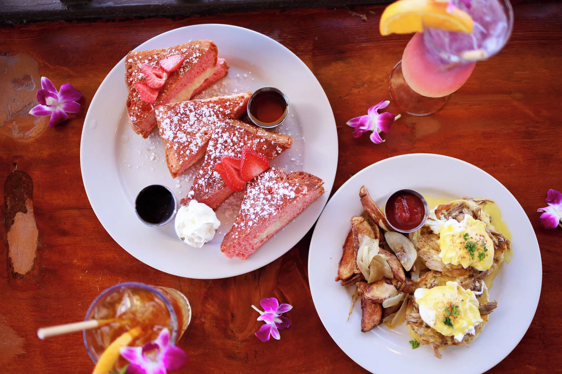 Overhead brunch with French toast, eggs, orchids, and drinks at Park Shore Waikiki.