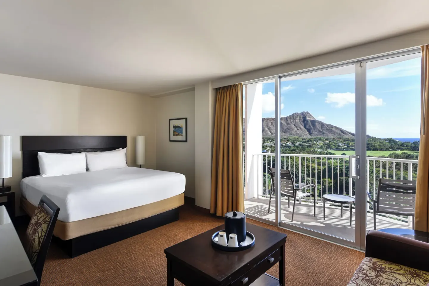 Junior Suite Ocean View king bed and balcony at Park Shore Waikiki.
