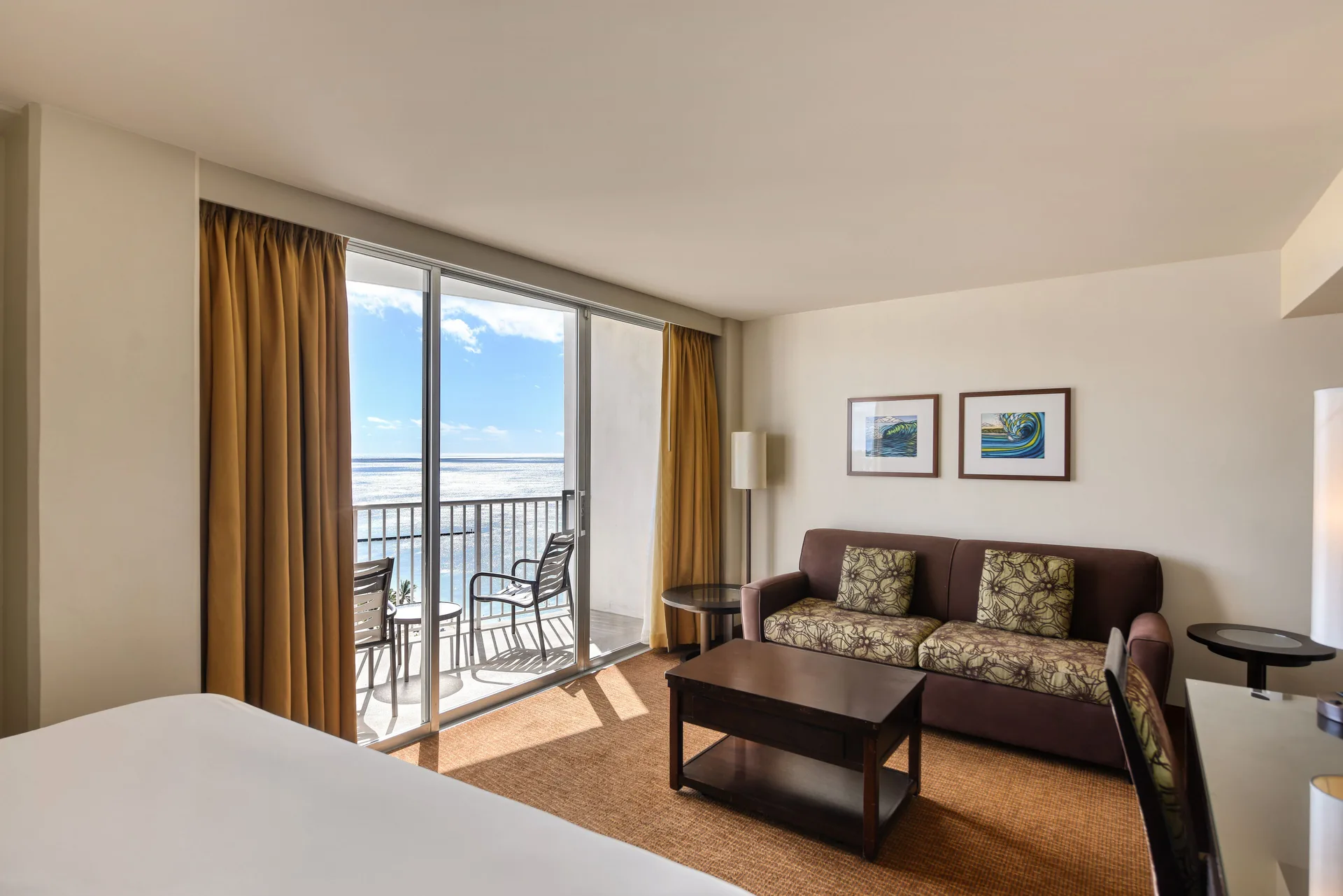 Junior Suite Ocean View living area and balcony at Park Shore Waikiki.