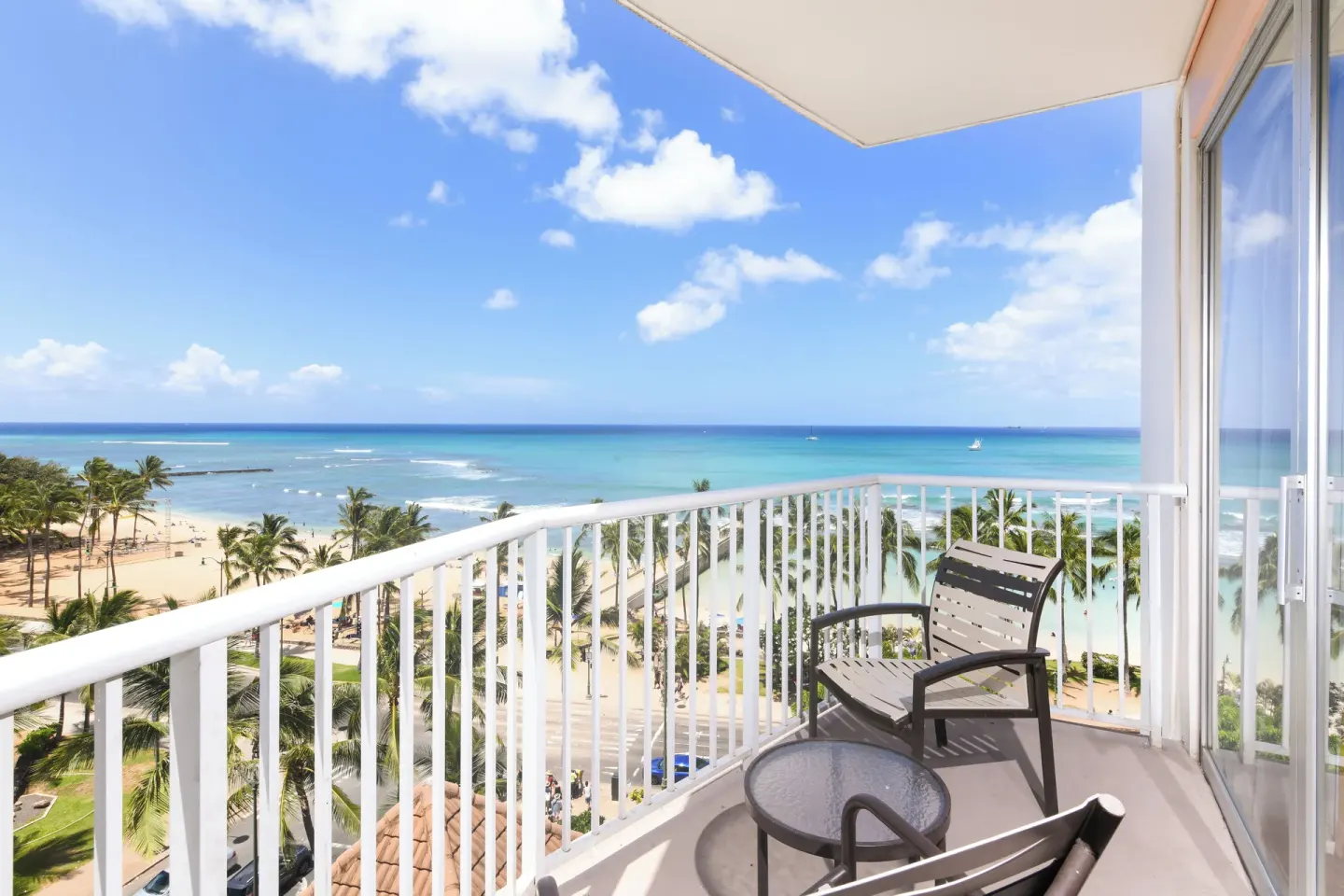 Furnished oceanfront balcony overlooking Waikiki Beach at Park Shore Waikiki.