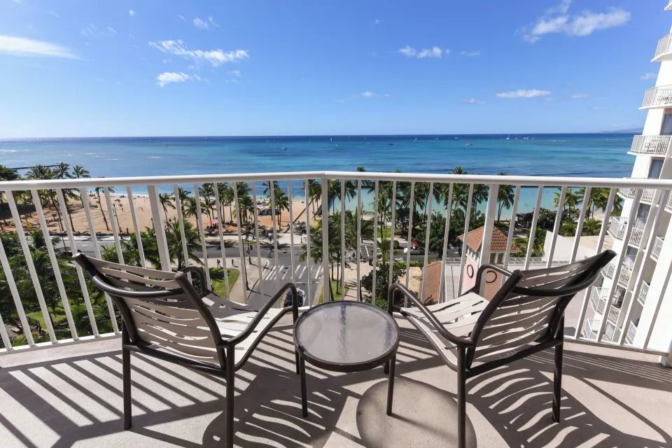Ocean View room balcony with chairs facing Waikiki Beach at Park Shore Waikiki.