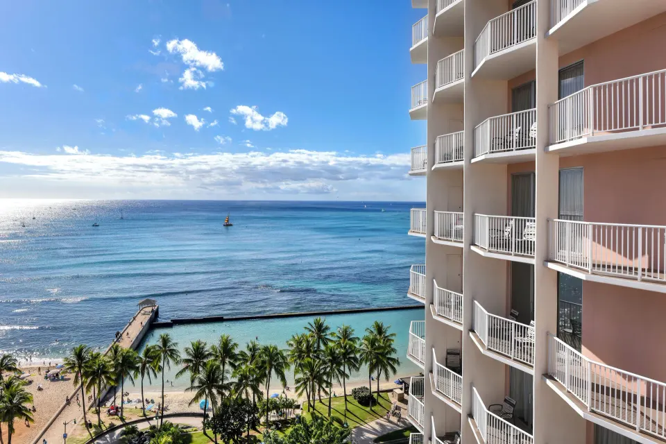 Oceanfront room balcony view of Waikiki Beach and the hotel tower at Park Shore Waikiki.