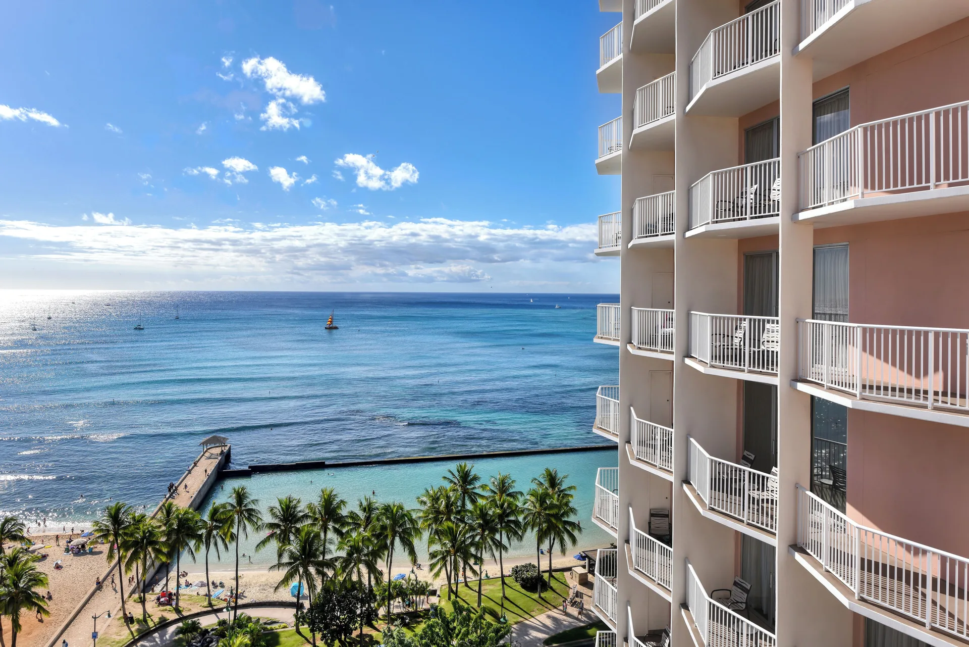 Oceanfront room balcony view of Waikiki Beach and the hotel tower at Park Shore Waikiki.