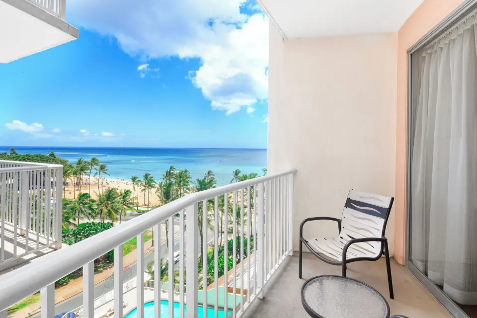 Partial ocean view balcony overlooking beach and palms at Park Shore Waikiki.