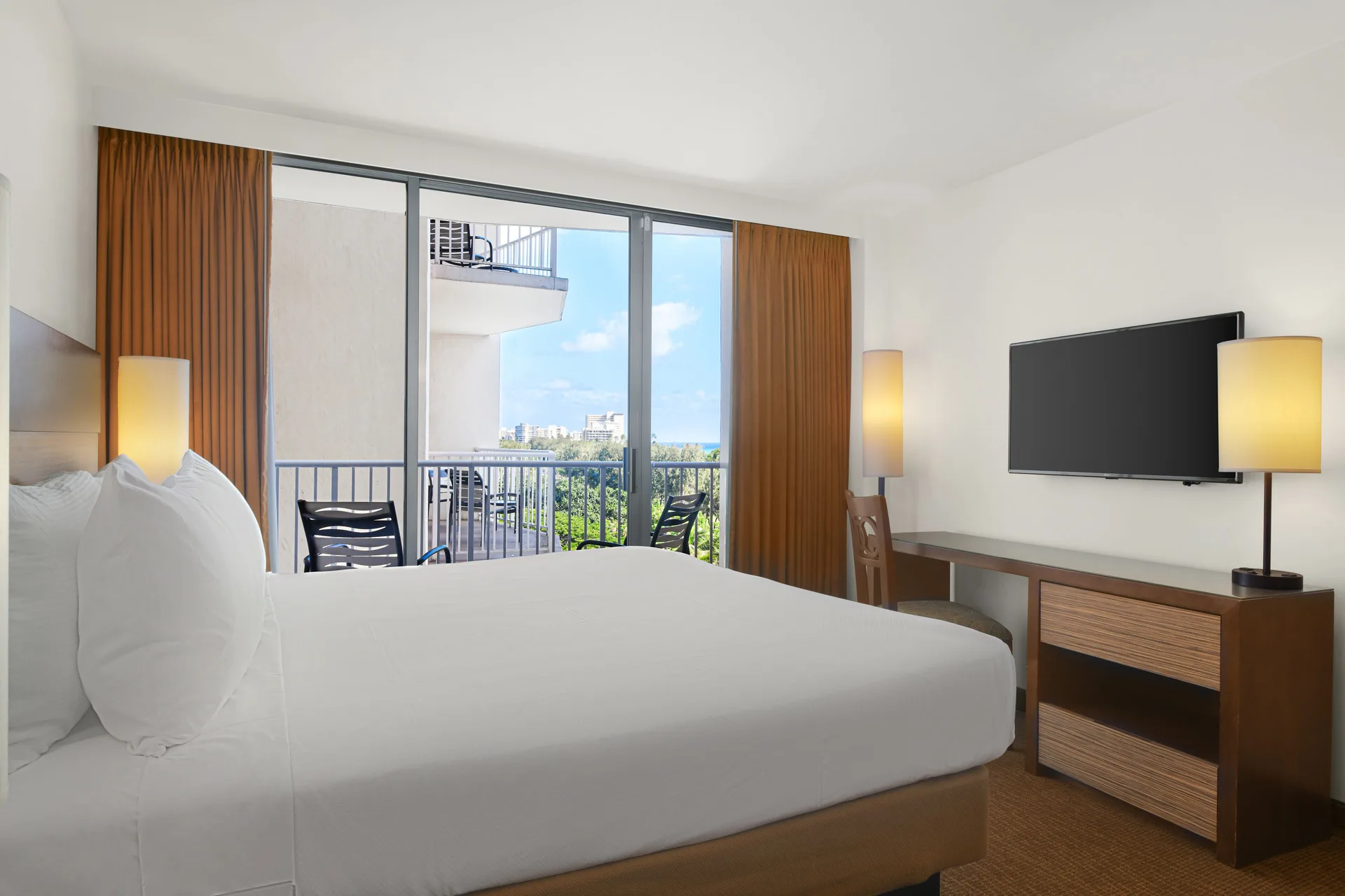 Partial Ocean View Room at Park Shore Waikiki with king bed, private balcony, and partial ocean view in Waikiki, Honolulu.