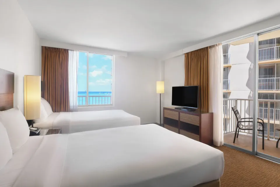 Two-bed partial ocean view guest room with balcony at Park Shore Waikiki.