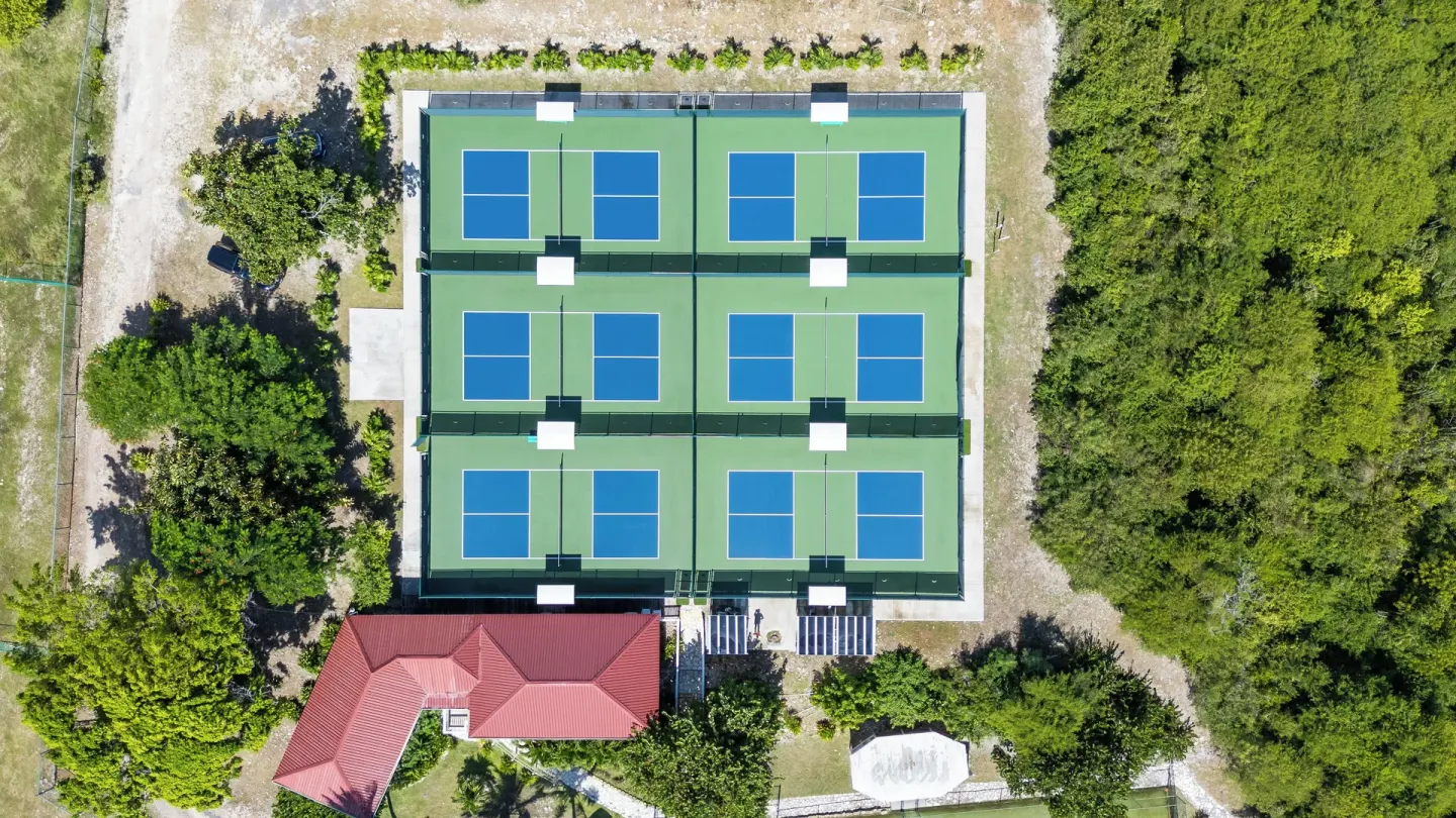 Aerial view of tennis and pickleball courts at Pineapple Beach Club Antigua.