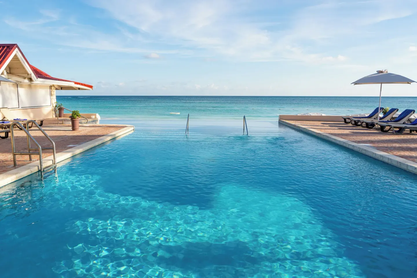 Beachfront infinity pool with ocean view at Pineapple Beach Club Antigua.