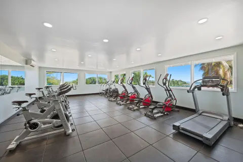 Fitness room with treadmills, bikes, and elliptical machines at Pineapple Beach Club Antigua.