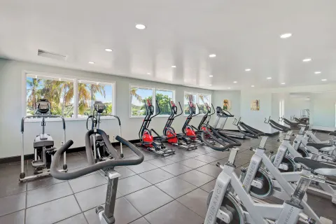 Fitness room with rows of exercise bikes and cardio machines at Pineapple Beach Club Antigua.