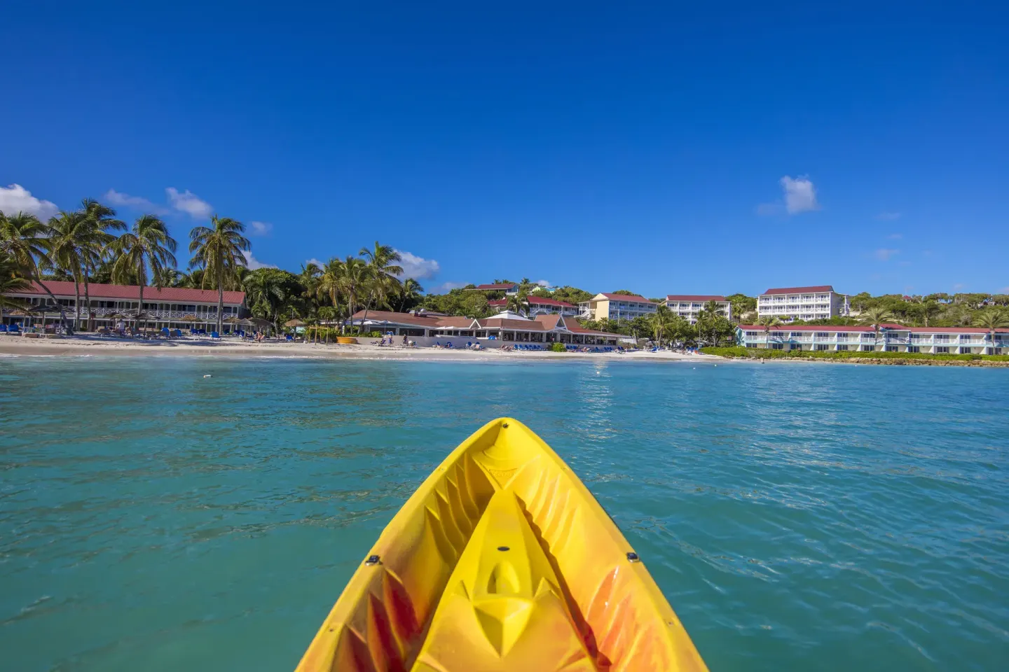 A yellow kayak points toward the beach at Pineapple Beach Club Antigua.