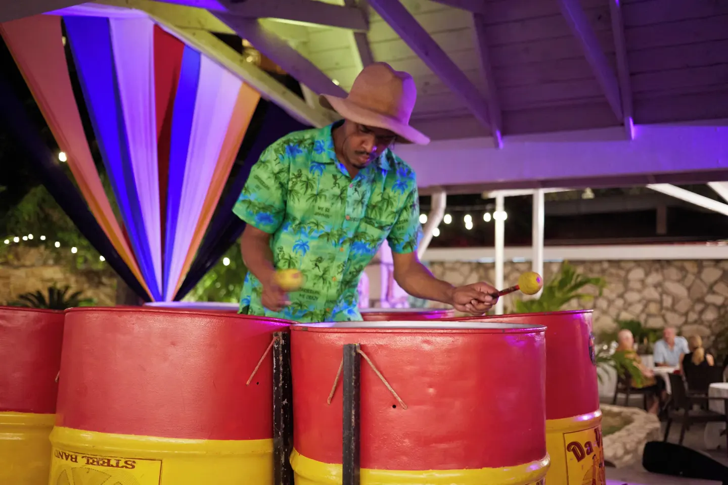 Steel pan musician performing at night at Pineapple Beach Club Antigua.
