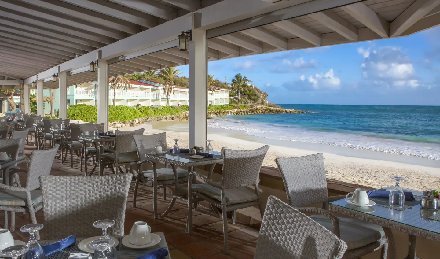 Covered beachfront dining terrace with ocean views at Pineapple Beach Club Antigua.