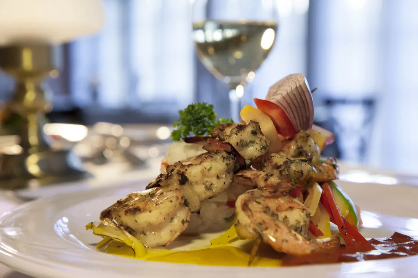 Plated grilled shrimp skewers with vegetables at Pineapple Beach Club Antigua.