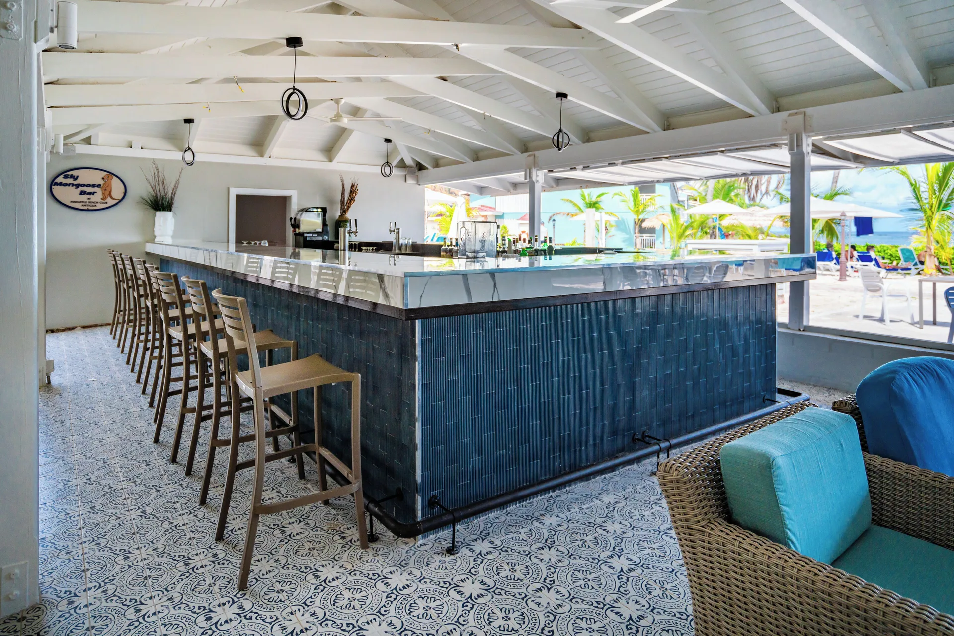 Sly Mongoose Bar with stool seating near the beach at Pineapple Beach Club Antigua.