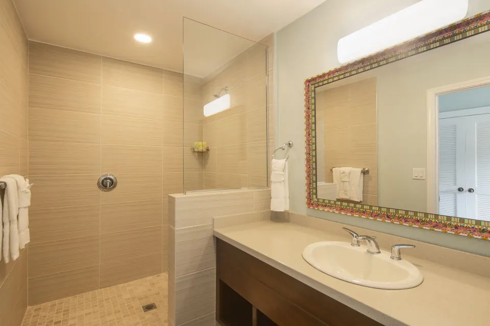 Beachfront room bathroom with walk-in shower at Pineapple Beach Club Antigua.