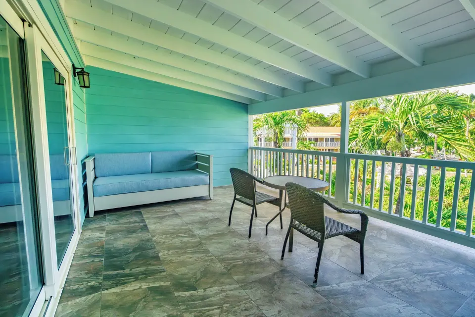 Covered beachfront balcony with seating at Pineapple Beach Club Antigua.