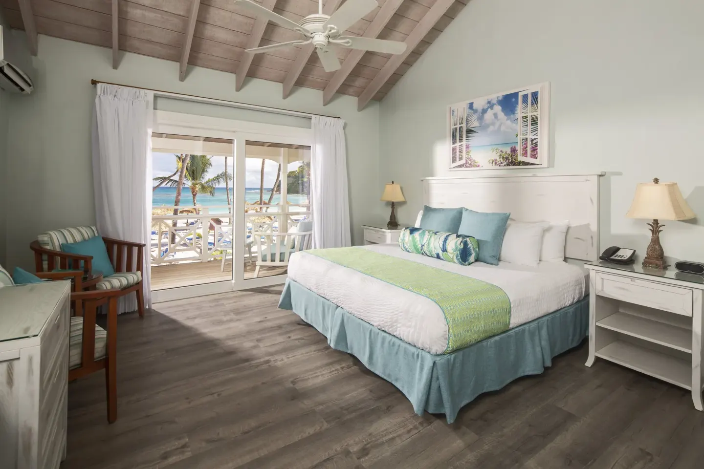 Beachfront king guest room with balcony and ocean view at Pineapple Beach Club Antigua.