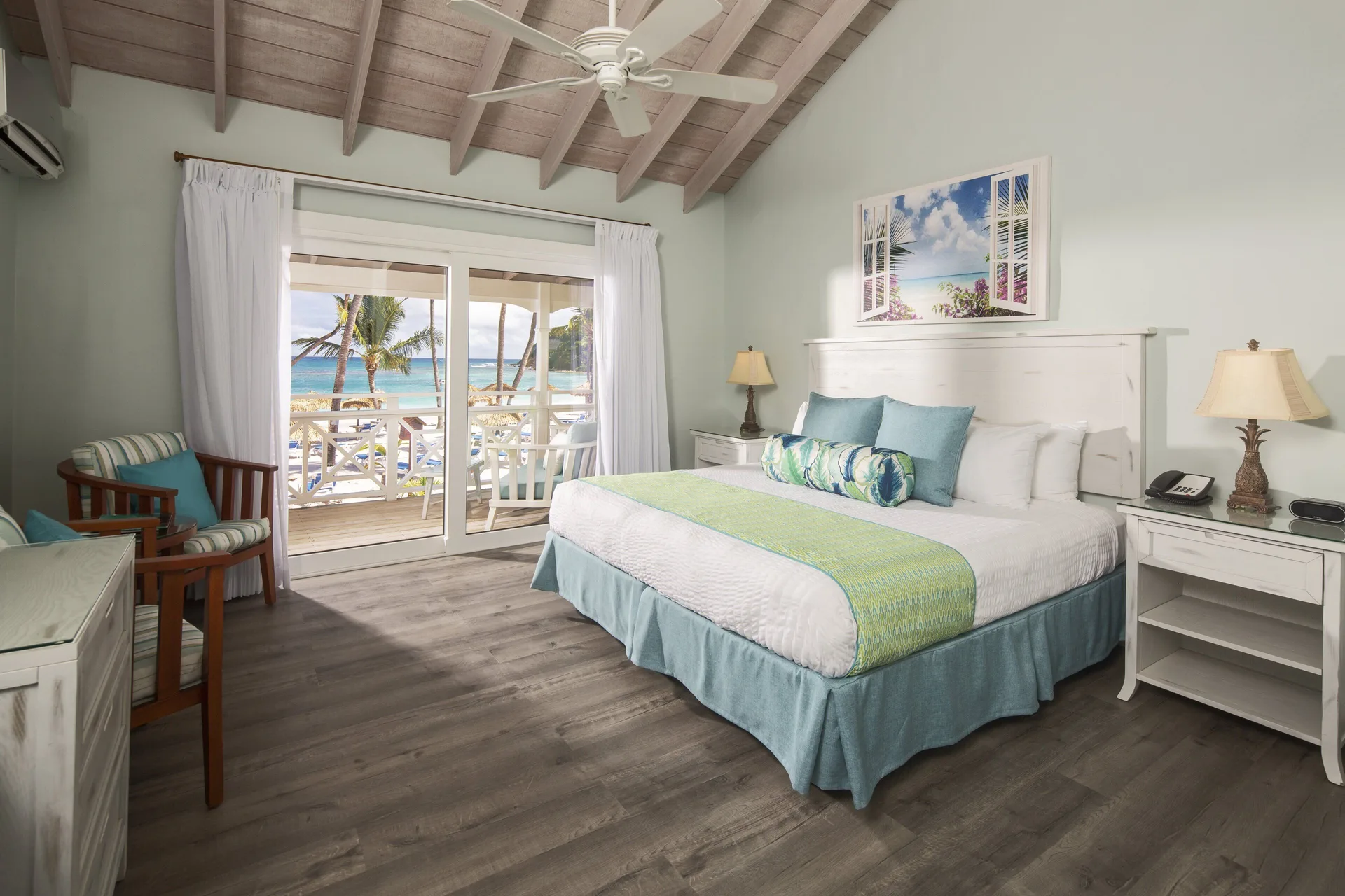 Beachfront king guest room with balcony and ocean view at Pineapple Beach Club Antigua.