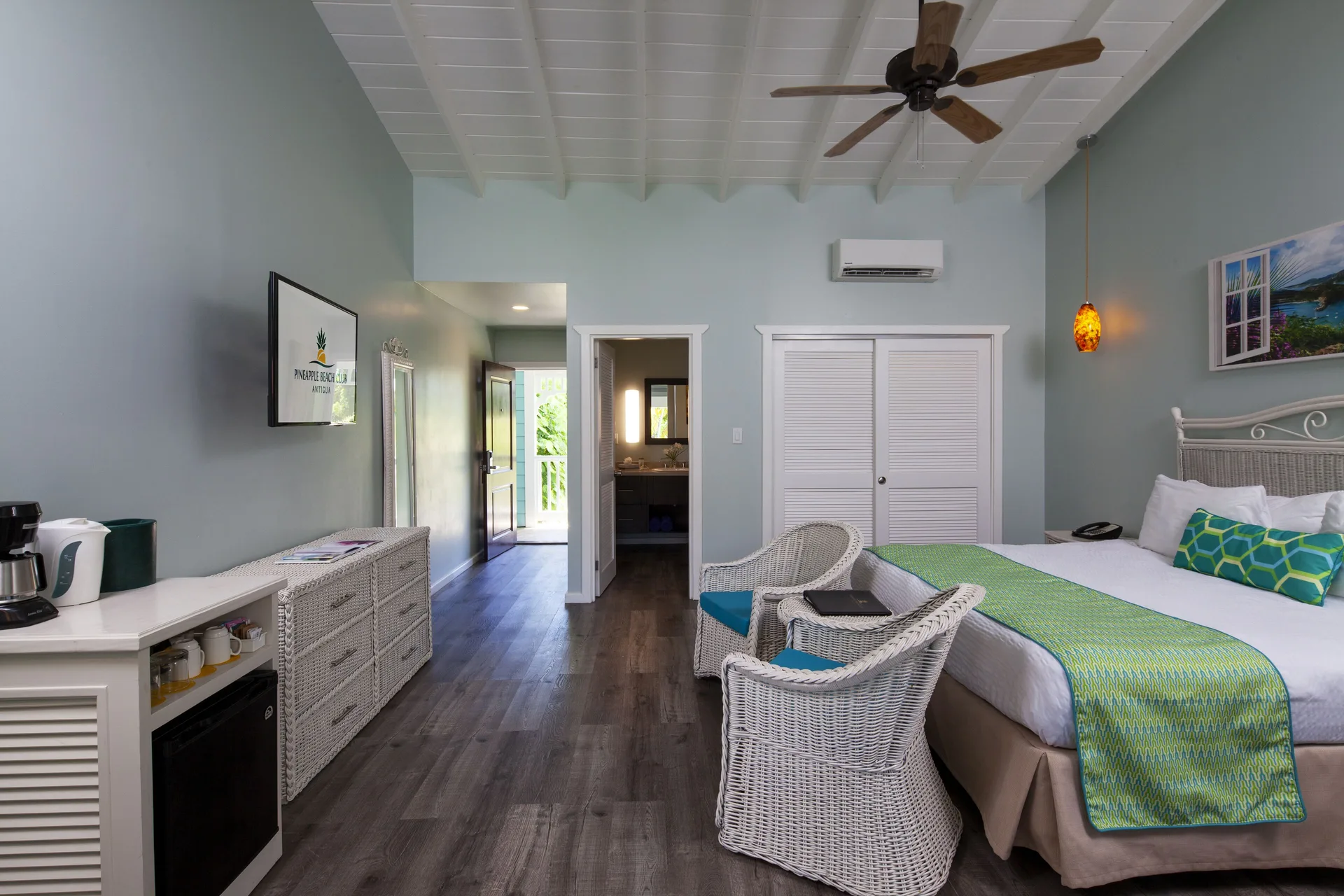 Gardenview Room with king bed, seating, and refreshment area at Pineapple Beach Club Antigua.