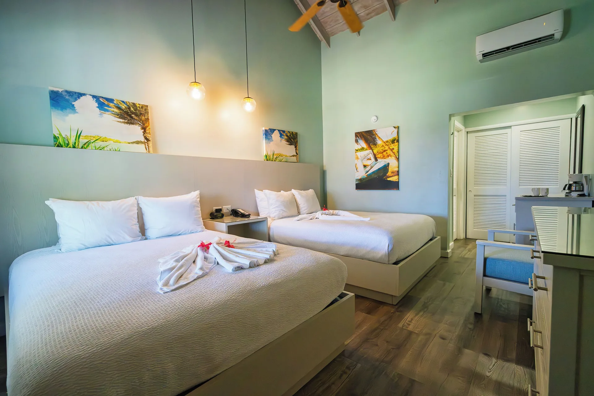 Gardenview Room with two beds and pendant lights at Pineapple Beach Club Antigua.