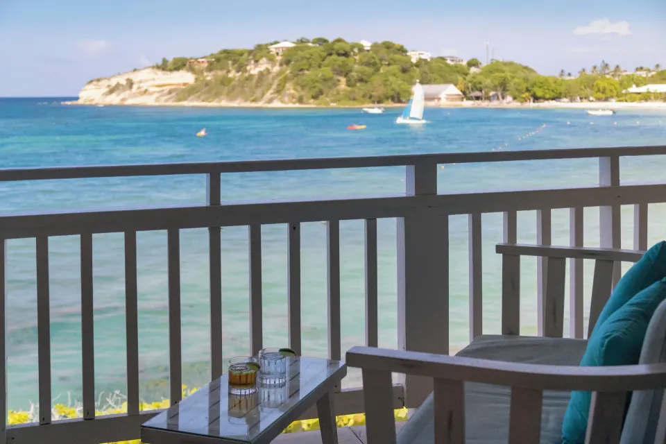 Oceanview balcony seating overlooking the bay at Pineapple Beach Club Antigua.
