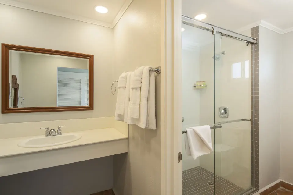 Oceanview room bathroom with vanity and glass shower at Pineapple Beach Club Antigua.